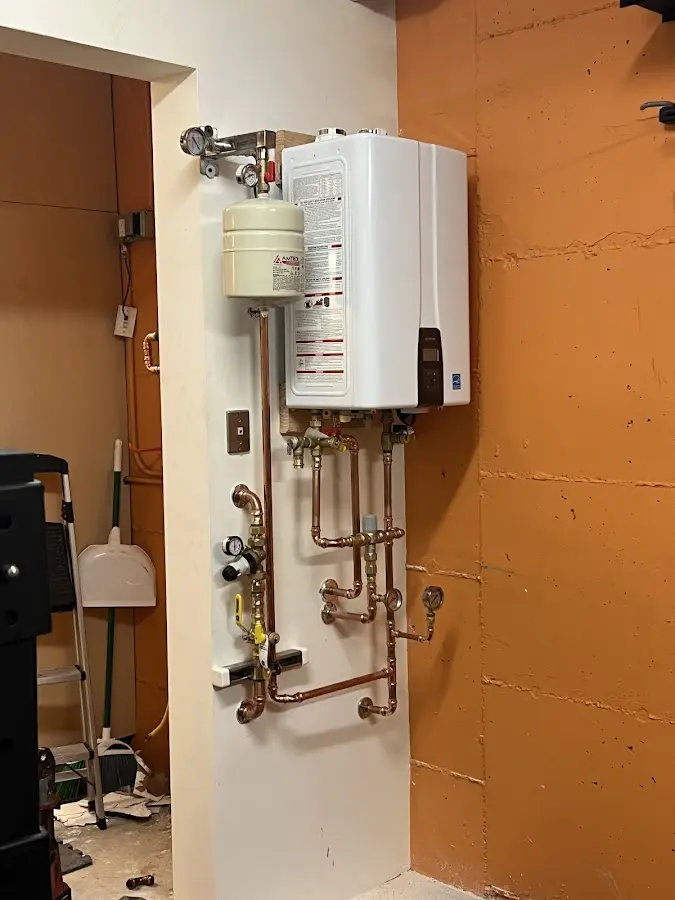Plumbing technician inspecting water heater connections in Swarthmore